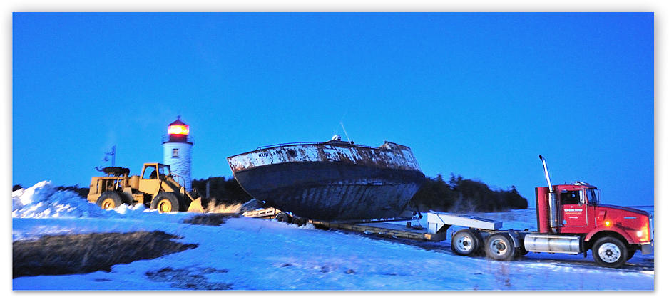 The water being down this year in Lake Michigan, the semi and loader move down the mini-bluff at Whiskey Point towards the water on the gravel shelf along the shore