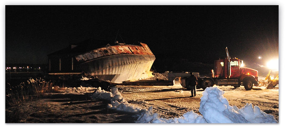 Getting dark, the Ruby Ann is unloaded from the trailer at water's edge