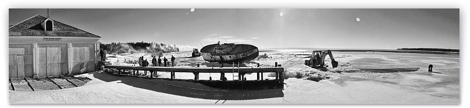 while chainsawas and backhoe work to make a hole in the ice large enough for the Ruby Ann to get up to ramming speed